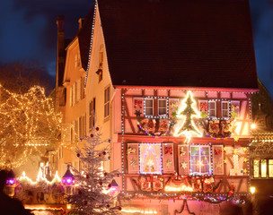Colmar christmas decoration on streets and old houses. Holiday illumination on buildings. - obrazy, fototapety, plakaty