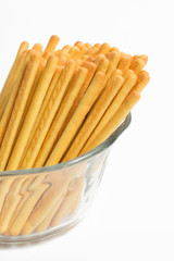 Cheese bread sticks in glass isolated on white background.