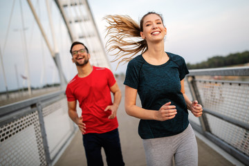 Healthy sporty young people jogging and running outdoors