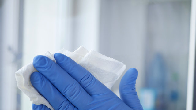 Close Up Man Hands with Blue Gloves Cleaning a Window6