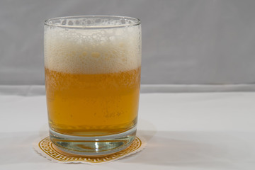 IPA with foam isolated, white background. Fresh india pale ale beer  with head in clear glass.