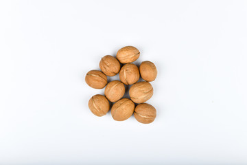 walnuts on a white background. Close up view of walnuts. Walnuts are 4 water, 15 protein, 65 fat and 14 carbohydrates, including 7 dietary fiber. In a reference portion of 100 grams.