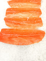 Fresh salmon lying on ice in the supermarket.