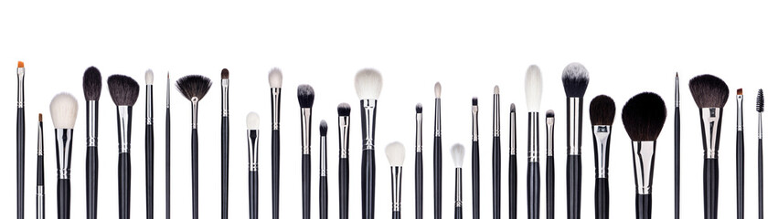 Set of make-up brushes lined up in alternating pattern. Isolated on white