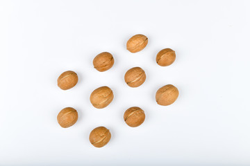 walnuts in symmetry. Close up view of walnuts. Walnuts are 4 water, 15 protein, 65 fat and 14 carbohydrates, including 7 dietary fiber. In a reference portion of 100 grams. A group of brown nuts arran