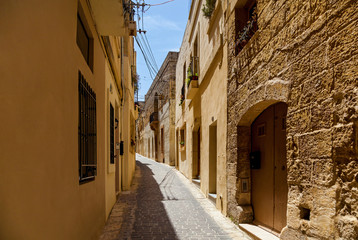 Fototapeta na wymiar A narrow medieval street with stone stairs in an old European town