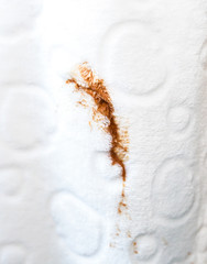 Woman spills coffee spot on white bathrobe. Dirty clothes.