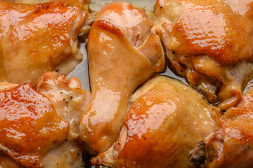 Background close-up homemade baked chicken pieces with soy sauce and spices