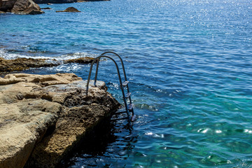 Fototapeta premium The metal ladder for the descent into the sea