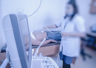 Blur photo - abstract image for the background. A medical professional performs an ultrasound test.