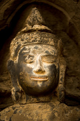 Fototapeta na wymiar praying buddah in aisa, close up of a sculpture with the hand and smiling face 