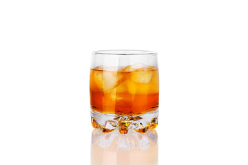 One glass of whiskey with ice cubes and reflection on white background isolated close up, golden alcohol cocktail, amber color cold icy drink, brown rum, yellow whiskey, brandy, scotch, cool beverage