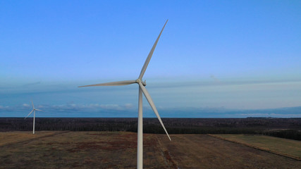 Wind turbine from aerial view - Sustainable development, environment friendly, renewable energy concept. Aerial View Of Wind Turbines In Blue Sky.