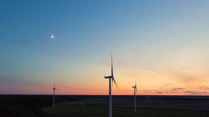 Obraz premium Wind turbine from aerial view - Sustainable development, environment friendly, renewable energy concept. Aerial View Of Wind Turbines In Blue Sky.