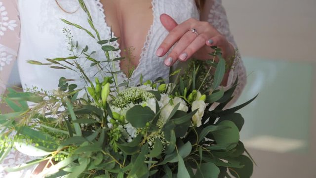 Women holding wedding flower bouquet