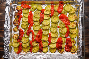 Homemade slices of bubbly and peppers baked on foil in the oven