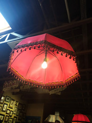 A delicate chandelier of fabric  hanging from the ceiling