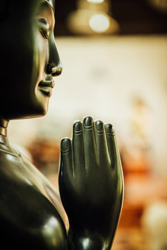 Praying Buddah In Aisa, Close Up Of A Sculpture With The Hand And Smiling Face Whoich Give You Peace And Tranquility For A Challenging Life Ahead 