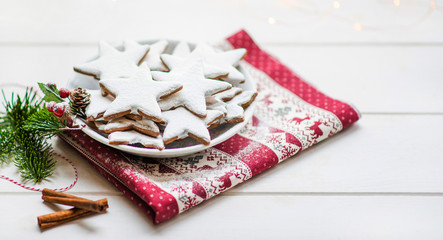 Vintage Christmas background. Christmas homemade gingerbread cookies on plate on white wooden table. Christmas, winter, new year concept. Copy space.