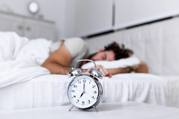 Sleep longer. Health care concept. Stages of sleep. Man awake unhappy with alarm ringing. Although...