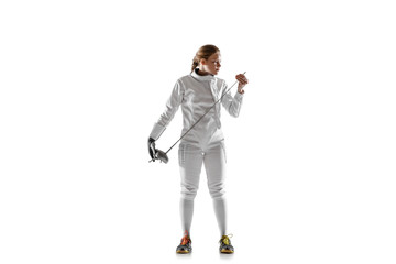 Teen girl in fencing costume with sword in hand isolated on white studio background. Young female caucasian model posing confident, preparing for fight. Copyspace. Sport, youth, healthy lifestyle.