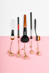 makeup brushes on a white and pink background. makeup brushes. Background. lies with copy space. beauty and cosmetics blogger