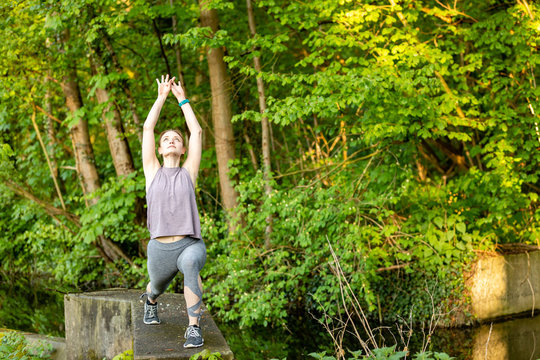 Young woman doing yoga exercises in nature