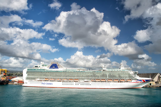 Big cruise ship P&O Cruises in harbour with beautiful waterscape and cloudy sky, horizontal picture