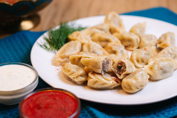 dumplings with dill on a white plate