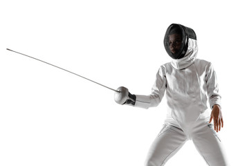 Teen girl in fencing costume with sword in hand isolated on white studio background. Young female...