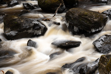Fototapeta na wymiar Frozen stones in Highland river