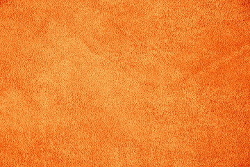 Suede leather. Genuine leather material. Orange background. Warm background. Skin testure. Suede.