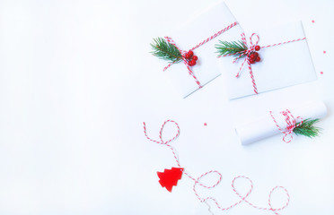 Christmas composition. Christmas gift, decoration, fir branches on light background. Flat lay, top view, copy space