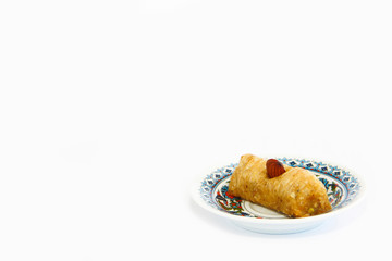 national oriental sweet baklava on a decorative plate on white background