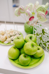 green apples and sweets on the table