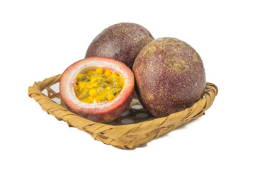 Whole passion fruit and a half maracuya fruit (Passiflora edulis) isolated on white background