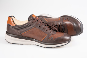 pair brown leather fashion man sneakers on white background