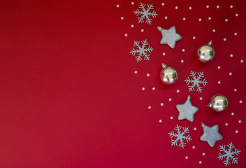 Fototapeta na wymiar Christmas still life. Silver decorative Christmas ornaments on a red background. Christmas, winter, new year concept. Flat lay, top view, copy space.