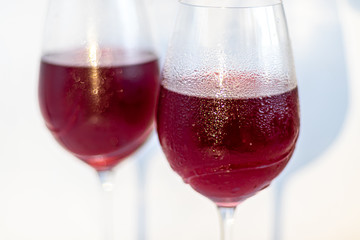 Two glasses with red wine. On white background.