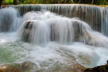 Fototapeta na wymiar Beautiful waterfall in the green deep forest