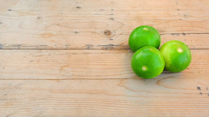 group of green lime on wooden table