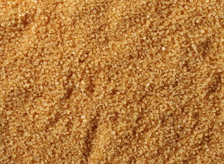 Brown cane sugar crystals background and texture