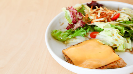 Grilled chicken steak with melted cheese and mixed salad