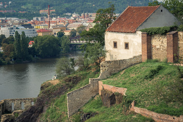 Fototapeta na wymiar old house with a stone fence on the steep bank of the Vltava river in Prague
