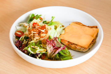 Grilled chicken steak with melted cheese and mixed salad