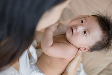 Mother staring at her cute little baby.