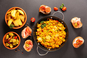 spanish food with paella, tapas and patatas bravas