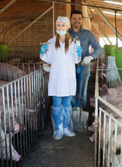 Smiling male farmer and female veterinarian