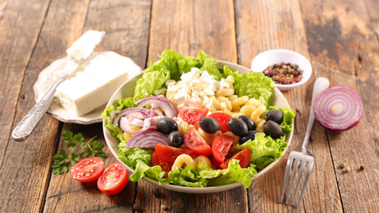 vegetable salad with feta cheese, tomato, olive, pasta and onion