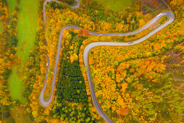 Autumn hilly landscape with winding road